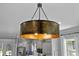 Statement lighting fixture hangs above the dining area, adjacent to the kitchen and countertops at 117 Palmola St, Lakeland, FL 33803