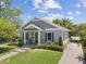 Well-maintained single-Gathering home with a manicured lawn, a cozy front porch and a paved walkway at 117 Palmola St, Lakeland, FL 33803