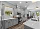 Modern kitchen boasts custom cabinets, quartz countertops, and stainless steel appliances at 117 Palmola St, Lakeland, FL 33803