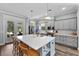 Well-lit kitchen features gray cabinets, stainless appliances, and an island with a white countertop at 117 Palmola St, Lakeland, FL 33803