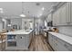 Bright kitchen boasts gray cabinetry, stainless steel appliances, and a spacious white countertop island at 117 Palmola St, Lakeland, FL 33803