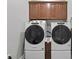 Well-organized laundry area with stacked washer and dryer, and cabinets at 117 Palmola St, Lakeland, FL 33803