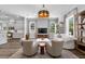 Inviting living space open to kitchen featuring hardwood floors, lots of natural light, and modern decor at 117 Palmola St, Lakeland, FL 33803