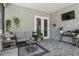 Bright sunroom with lots of greenery, patio furniture, and a door to the back at 117 Palmola St, Lakeland, FL 33803