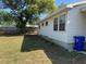 Lush backyard featuring green grass, a wood fence, and the side of the home at 1226 N Brunnell Pkwy, Lakeland, FL 33805