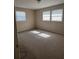Bedroom showcasing natural light streaming through windows and neutral-toned carpet at 1226 N Brunnell Pkwy, Lakeland, FL 33805