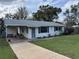 Charming single-story home with a cozy front porch and well-maintained lawn at 1226 N Brunnell Pkwy, Lakeland, FL 33805