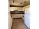 Kitchen with white cabinets, tile flooring, and appliances including a refrigerator and dishwasher at 1226 N Brunnell Pkwy, Lakeland, FL 33805