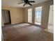 Open-concept living room featuring carpet and unique windows that provide ample natural light at 1226 N Brunnell Pkwy, Lakeland, FL 33805