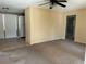 A living room featuring a ceiling fan, carpet, and an entrance to the kitchen area at 1226 N Brunnell Pkwy, Lakeland, FL 33805