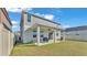 Home featuring a covered patio that leads to a green lawn at 1280 Denali Dr, Winter Haven, FL 33880