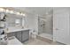 Bathroom with double sink vanity, glass shower, and bright lighting at 1280 Denali Dr, Winter Haven, FL 33880