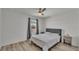 Bedroom featuring wood flooring, ceiling fan, and natural light from the window at 1280 Denali Dr, Winter Haven, FL 33880
