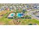 Community pool with lounge chairs, palm trees, and lush landscaping creates a resort-like atmosphere at 1280 Denali Dr, Winter Haven, FL 33880