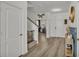 Bright entryway featuring wood-look flooring, stairs, and stylish decor at 1280 Denali Dr, Winter Haven, FL 33880