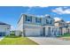 Charming two-story home featuring a two-car garage, landscaped front yard, and inviting curb appeal at 1280 Denali Dr, Winter Haven, FL 33880