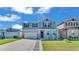 Charming two-story home featuring a manicured lawn, two car garage, and inviting entrance at 1280 Denali Dr, Winter Haven, FL 33880