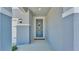 Inviting front entrance featuring a stylish blue door with a welcome sign and modern lighting at 1280 Denali Dr, Winter Haven, FL 33880