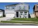 Charming two-story home with a well-manicured lawn, landscaping, and a two-car garage at 1280 Denali Dr, Winter Haven, FL 33880