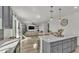 Modern kitchen with stainless appliances and an island that connects to a living area at 1280 Denali Dr, Winter Haven, FL 33880