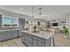 Open-concept kitchen offering a spacious island with seating and views into the living area at 1280 Denali Dr, Winter Haven, FL 33880