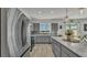 Bright kitchen featuring stainless steel appliances and a center island overlooking backyard at 1280 Denali Dr, Winter Haven, FL 33880