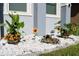 Landscaped garden area featuring vibrant flowers, lush greenery, and decorative white rock at 1280 Denali Dr, Winter Haven, FL 33880