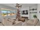 Cozy living room featuring modern furniture, a large window, and a decorative TV accent wall at 1280 Denali Dr, Winter Haven, FL 33880
