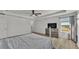 Bright bedroom featuring wood flooring, a ceiling fan, and views of the water at 1280 Denali Dr, Winter Haven, FL 33880