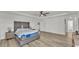 Spacious main bedroom featuring tray ceiling, ceiling fan, wood flooring, and ensuite bath at 1280 Denali Dr, Winter Haven, FL 33880