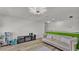 Spacious playroom with hardwood floors, comfortable sofa, and modern lighting at 1280 Denali Dr, Winter Haven, FL 33880