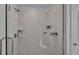 Glass shower featuring marble tile with built-in shelves and a modern shower head at 1280 Denali Dr, Winter Haven, FL 33880