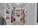 Walk-in closet featuring custom built-ins with shelving and drawers for ample storage at 1280 Denali Dr, Winter Haven, FL 33880