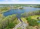 Aerial view showcasing a boat ramp providing access to a serene lake, surrounded by lush greenery at 13137 Lake Butler Blvd, Windermere, FL 34786