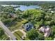 Expansive home with large lawn, circular driveway, and proximity to a scenic lake visible from above at 13137 Lake Butler Blvd, Windermere, FL 34786