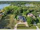 Beautiful aerial view of the house with circular drive and lush lawn, near a picturesque lake at 13137 Lake Butler Blvd, Windermere, FL 34786