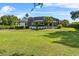 Expansive backyard featuring lush greenery, tropical landscaping, and a screened pool area perfect for outdoor living at 13137 Lake Butler Blvd, Windermere, FL 34786