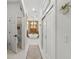 Bright bathroom hallway with an open view of a soaking tub next to a window at 13137 Lake Butler Blvd, Windermere, FL 34786