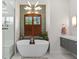 Modern bathroom with a sleek standalone tub and unique lighting fixture at 13137 Lake Butler Blvd, Windermere, FL 34786