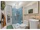 Modern bathroom with a glass-enclosed shower featuring blue tile, sleek fixtures, and a floating vanity at 13137 Lake Butler Blvd, Windermere, FL 34786