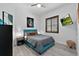 Stylish bedroom with a turquoise headboard, modern lamps, and a mounted TV at 13137 Lake Butler Blvd, Windermere, FL 34786