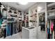 Spacious closet featuring organized shelving, hanging storage, and an island with glass display tops at 13137 Lake Butler Blvd, Windermere, FL 34786