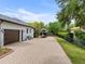 Spacious brick driveway with a two-car garage and a boat, providing ample parking space at 13137 Lake Butler Blvd, Windermere, FL 34786