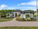 Beautiful white home with manicured lawn and a metal roof, perfect for curb appeal at 13137 Lake Butler Blvd, Windermere, FL 34786