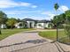 Stately home with a grand entrance, lush landscaping, and a private gated driveway at 13137 Lake Butler Blvd, Windermere, FL 34786