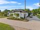 Impressive home with a circular driveway, mature palm trees, and ample parking at 13137 Lake Butler Blvd, Windermere, FL 34786