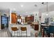 Open kitchen with bar, custom cabinets, granite counters, and adjacent eating nook at 13137 Lake Butler Blvd, Windermere, FL 34786