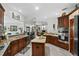 This open kitchen has an island, stainless appliances, and access to multiple living spaces at 13137 Lake Butler Blvd, Windermere, FL 34786