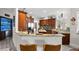 This open kitchen has a bar, custom cabinets, and granite countertops at 13137 Lake Butler Blvd, Windermere, FL 34786