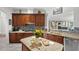 Stylish kitchen boasts custom wood cabinetry, granite countertops, and stainless steel appliances at 13137 Lake Butler Blvd, Windermere, FL 34786